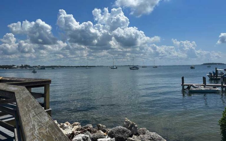 bay view from pier with jetty rocks and boats at bridge street pier bradenton beach anna maria island