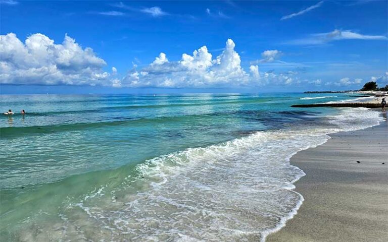 beach with green water and white surf at coquina beach bradenton anna maria island