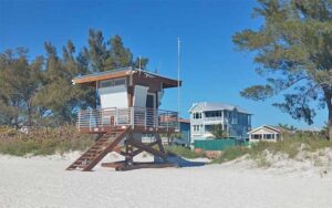 beach with trees and lifeguard stand at cortez beach bradenton anna maria island