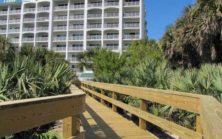 boardwalk across dunes to high rise hotel at the resort on cocoa beach