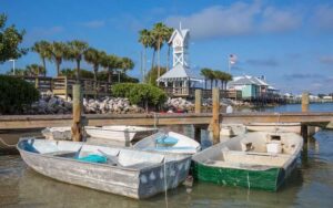 boats on dock with pier and clock tower at historic bridge street bradenton beach anna maria island