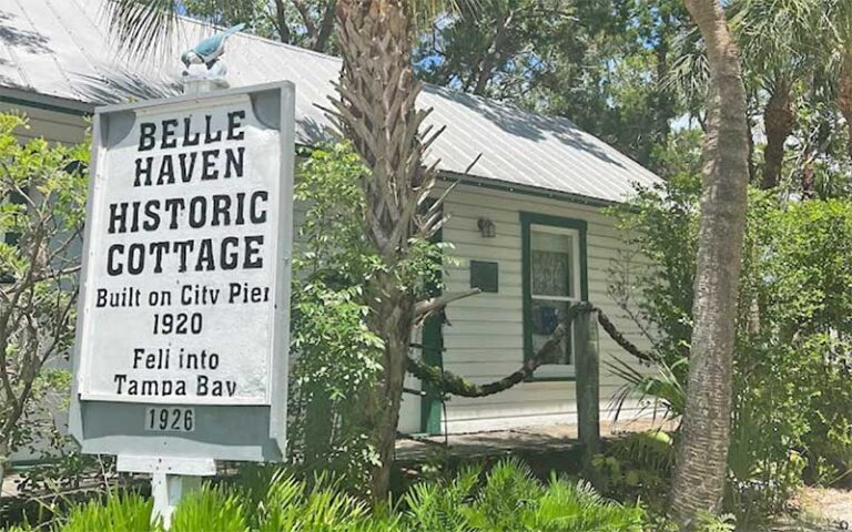 cottage in woods with marker sign at anna maria island historical society