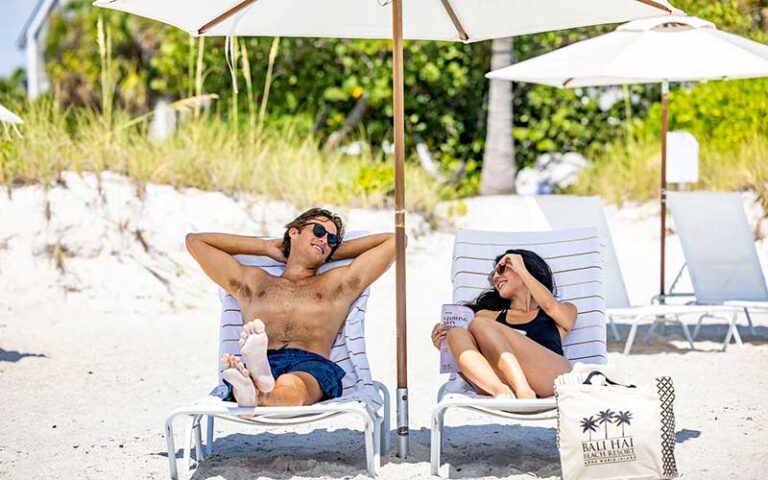 couple in loungers on beach at bali hai beach resort holmes anna maria island