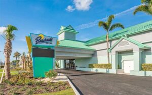 drive up entrance to hotel with teal accents at beachside hotel suites cocoa beach