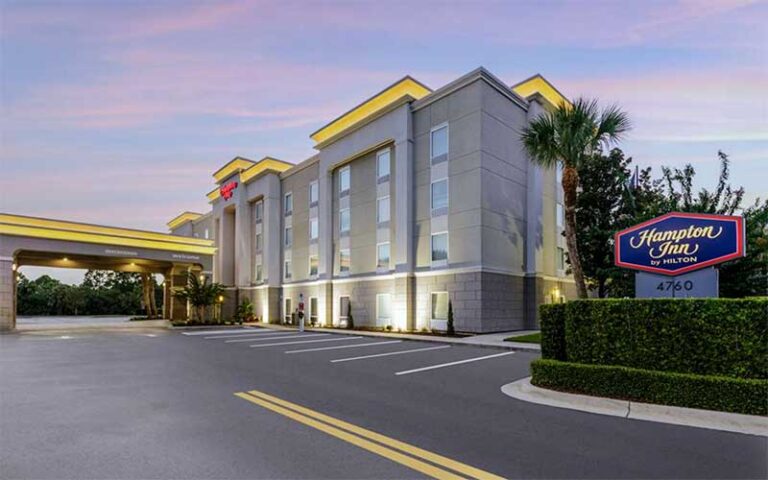 four story hotel with drive up entrance and twilight sky at hampton inn titusville