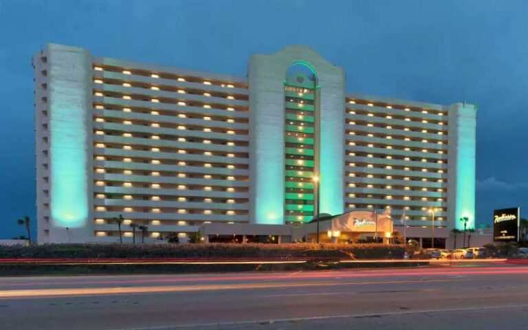 high rise hotel night exterior with sign at radisson suite hotel oceanfront melbourne beach