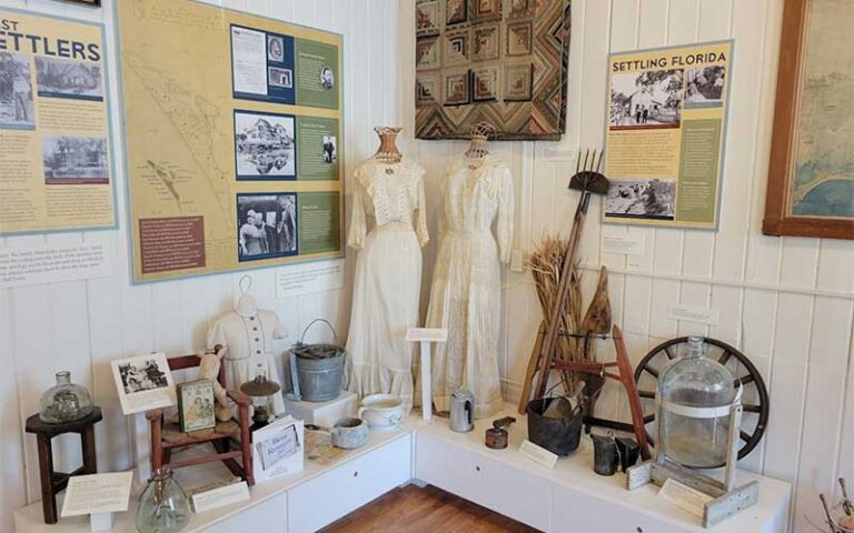 interior museum exhibit with old clothings and tools at anna maria island historical society