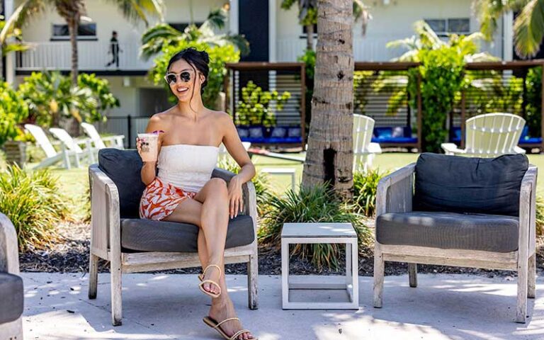 lady with drink in cabana area at bali hai beach resort holmes anna maria island