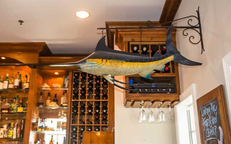 marlin pendant decor with wine shelves and bar at the waterfront restaurant anna maria island