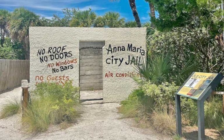 old framed out jailhouse with marker at anna maria island historical society