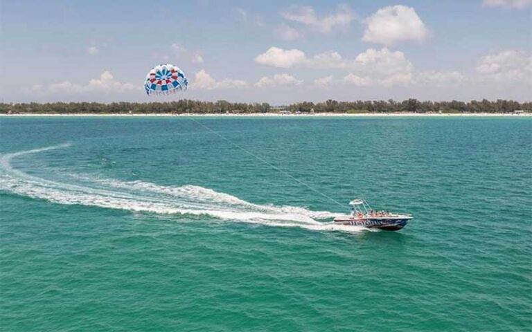 parasailing boat curving across bay at bradenton beach marina anna maria island