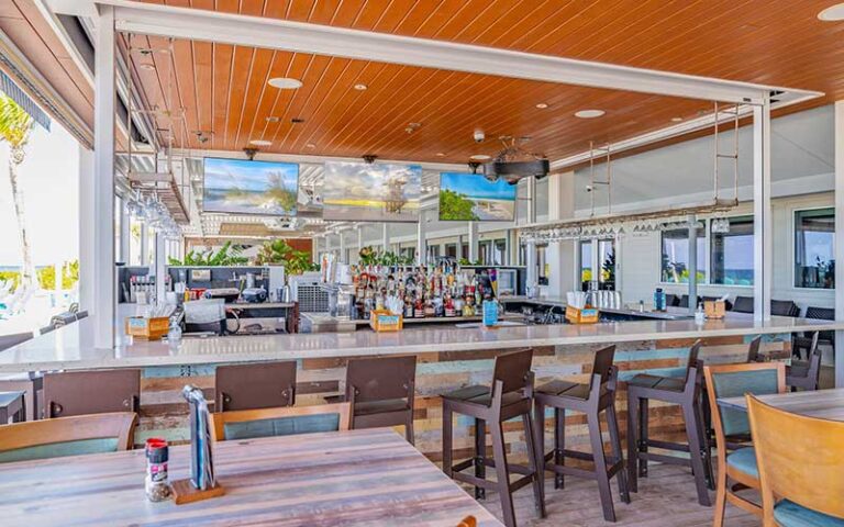 patio dining and bar with screens at beach house waterfront restaurant bradenton beach anna maria island