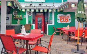 patio dining area with bar and sign at freckled fin irish pub holmes beach anna maria island