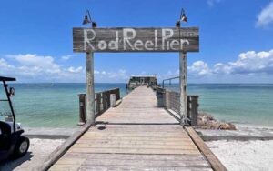 pier entrance with sign and diner over water at rod reel pier anna maria island