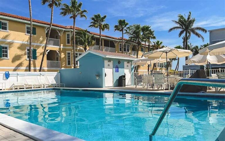 pool area with hotel and palms at silver surf anna maria island at bradenton beach