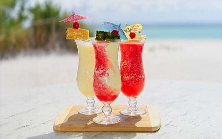 red and white cocktails in parfait glasses on beach at beach house waterfront restaurant bradenton beach anna maria island