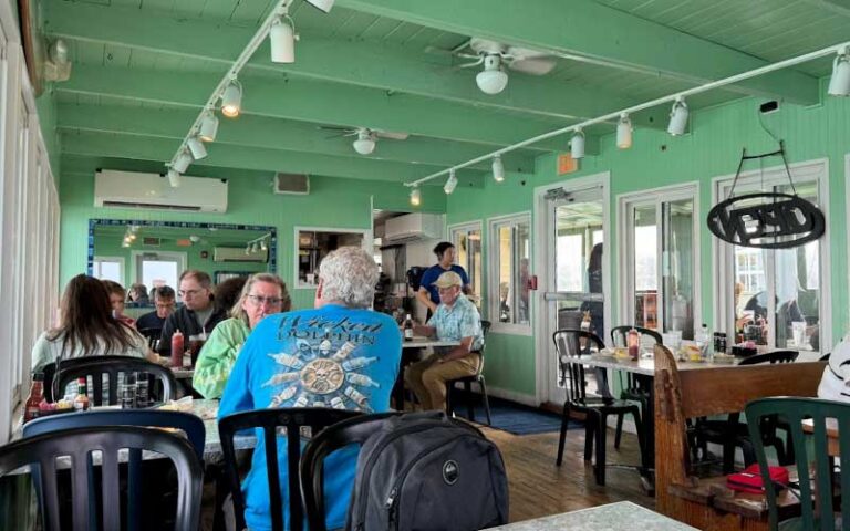 restaurant interior with green accents and diners at rod reel pier anna maria island