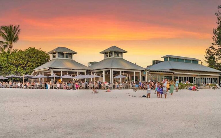 restaurant with diners on beach and twilight sky at sandbar seafood spirits anna maria island