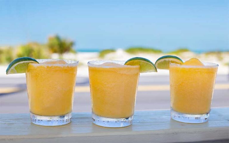 row of margarita cocktails with beach view at wicked cantina bradenton beach anna maria island