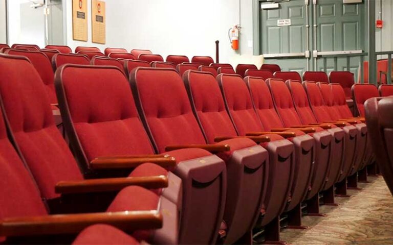 rows of red seats in theater at the island players anna maria