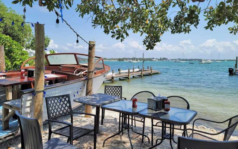 shady seating with dock and boat table at bridge tender inn bradenton beach anna maria island