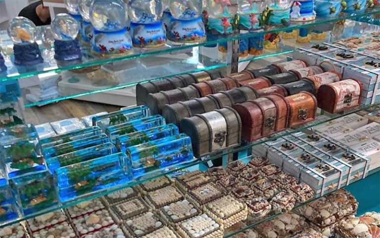 shelf of souvenir snowglobes and figurines at bridge street bazaar bradenton beach anna maria island