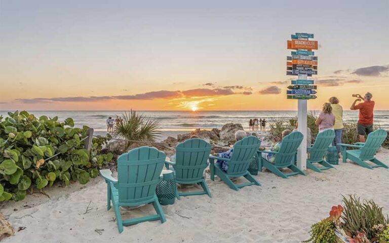 sunset view from beach with blue chairs at beach house waterfront restaurant bradenton beach anna maria island