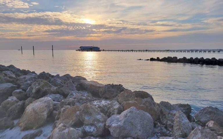 view from jetty of pier with building and twilight sky at anna maria city pier island