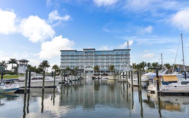 view from marina of high rise hotel and boat at compass hotel anna maria sound by margaritaville bradenton