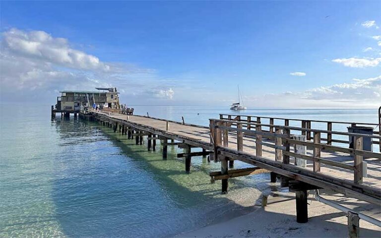 view from shore of long pier with restaurant at end at rod reel pier anna maria island