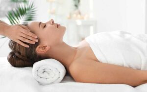 young woman in spa with hands on temples at zillian holistic wellness orlando kissimmee